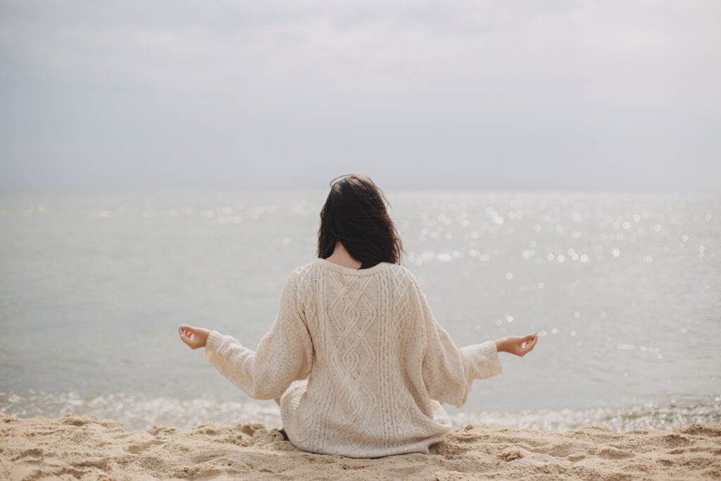 beautiful woman meditating on sandy beach at sea 2021 09 03 07 43 13 utc 正念,疫情焦慮,轉念,正念意思,正念練習,何謂正念,正念定義,瑜珈正念,焦慮